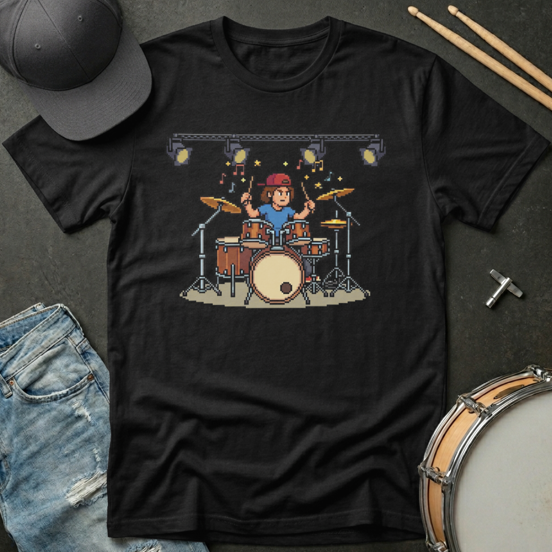 Black t-shirt with pixel art of a drummer on a dark surface with drumsticks and jeans.