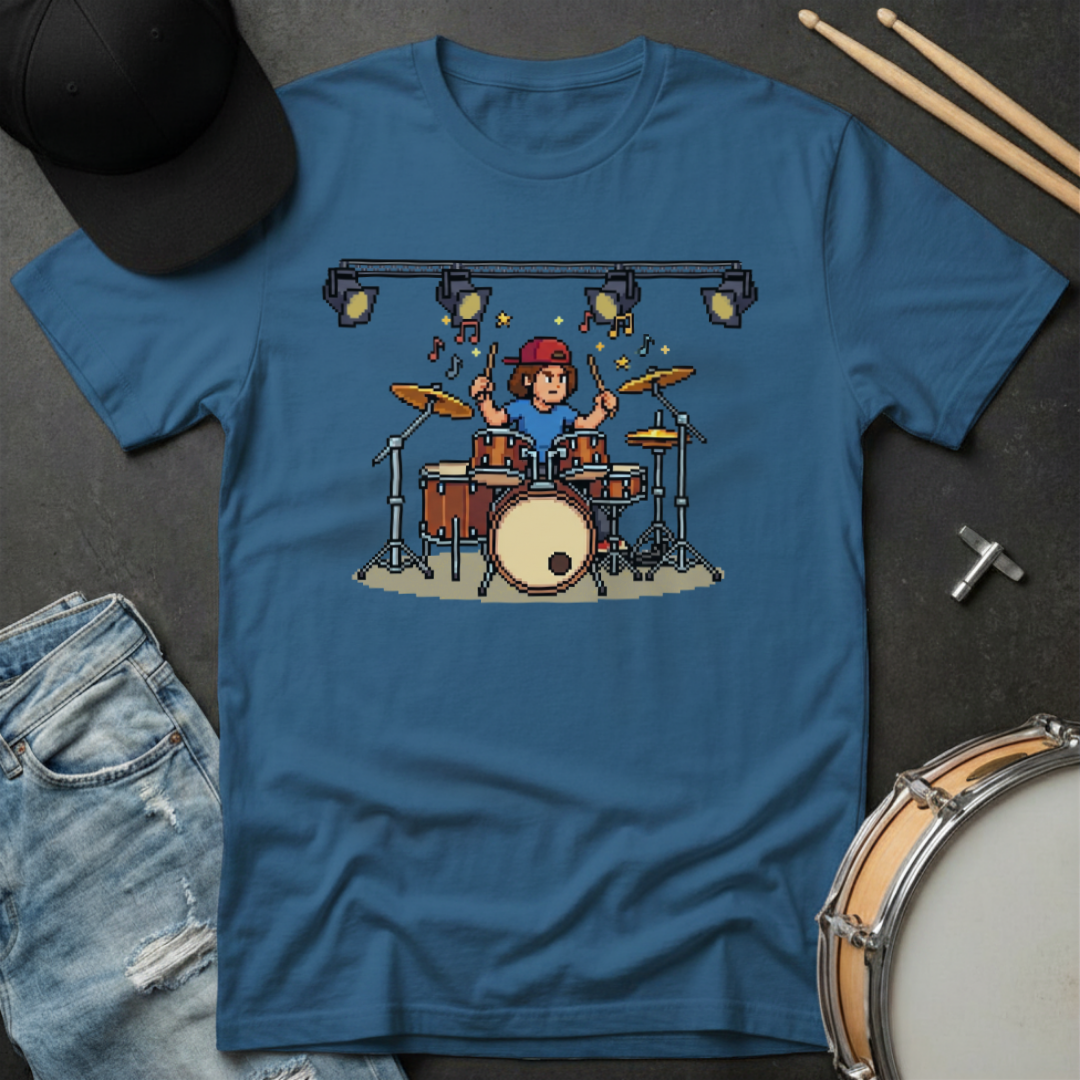 Blue t-shirt with a graphic of a drummer on a dark surface with drumsticks and a cap.