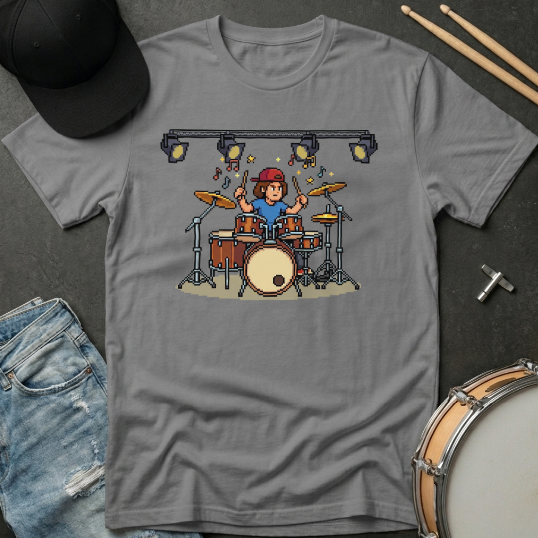 Gray t-shirt with pixel art of a drummer on a dark surface with drumsticks and jeans.