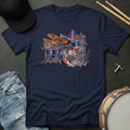 Navy blue t-shirt with a graphic of a drummer and drum set, surrounded by casual items like jeans and a cap.