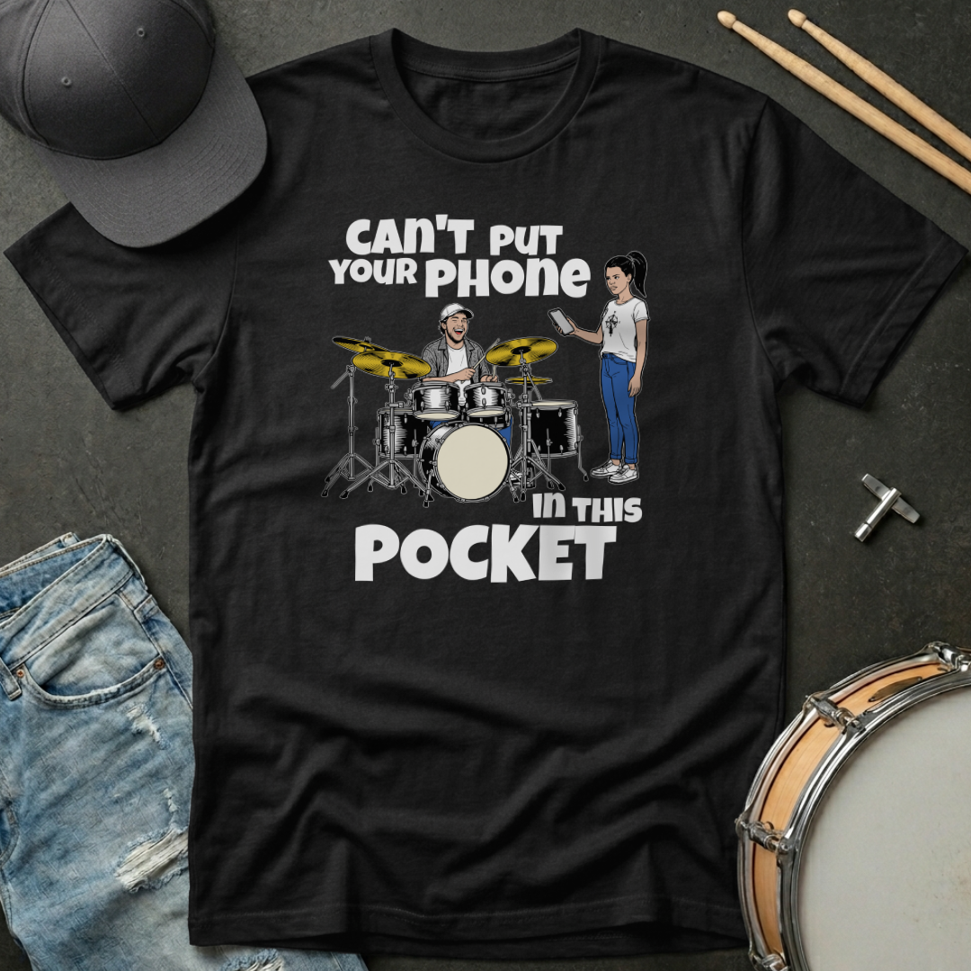 Black t-shirt with graphic design and text on a dark surface with musical instruments.
