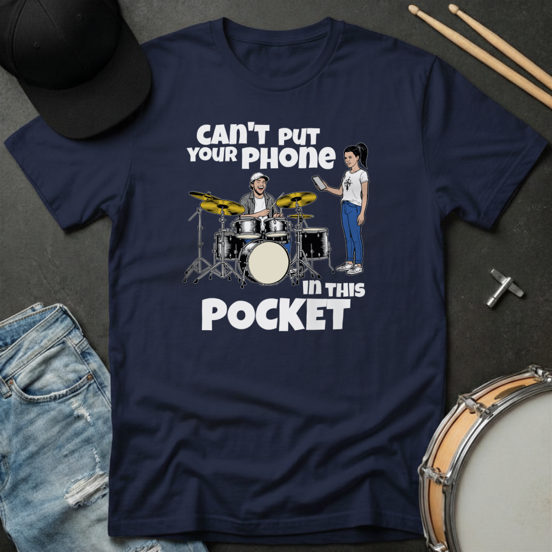 Navy blue t-shirt with graphic design and text on a dark surface with accessories.