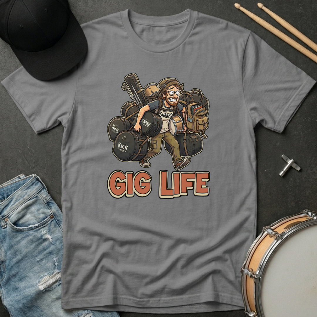 Gray t-shirt with 'Gig Life' graphic featuring a drummer, surrounded by drumsticks and jeans on a dark surface.