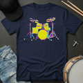 Navy blue t-shirt with colorful drum set graphic, surrounded by casual items on a dark surface.