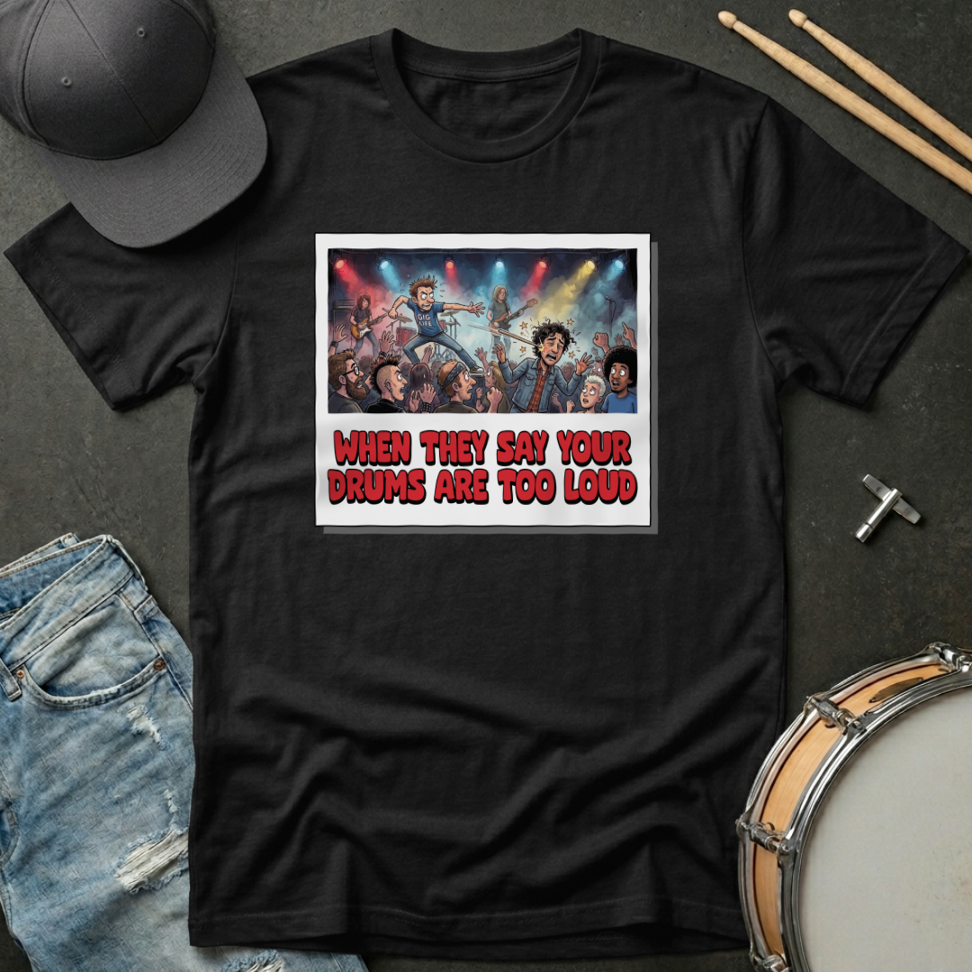 Black t-shirt with graphic design and text on a dark surface with accessories.
