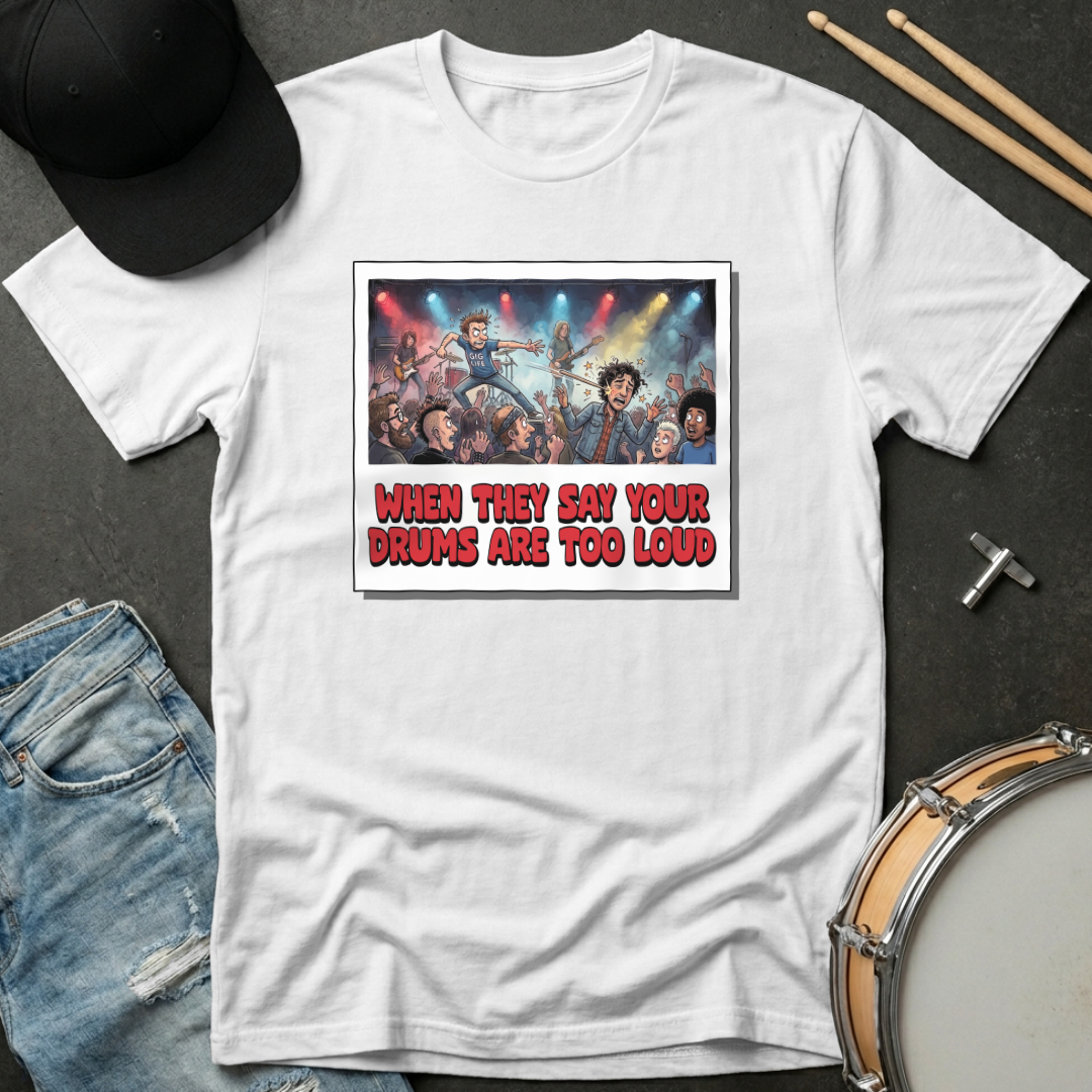 White t-shirt with graphic design and text on a dark surface with casual items.