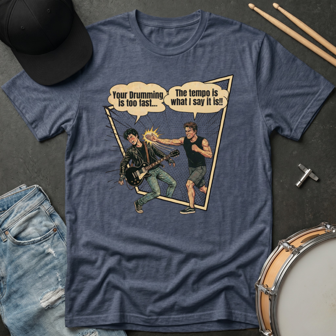 Blue t-shirt with graphic design of two musicians and text on a dark surface with drumsticks and jeans.